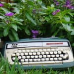 typewriter in flower bed