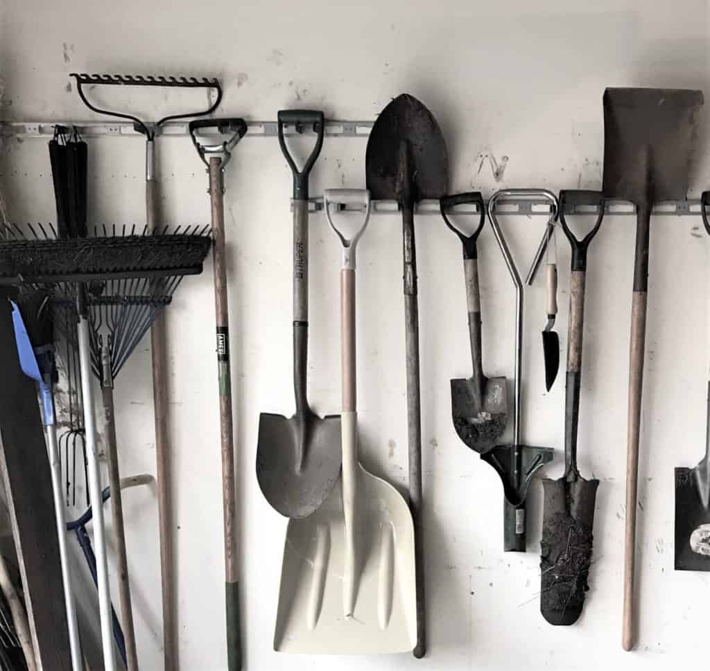 tools line a garage wall for work word worship in the garden