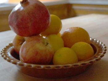 Pomegranate perched upon a fruit bowl, a delicious Bible treat