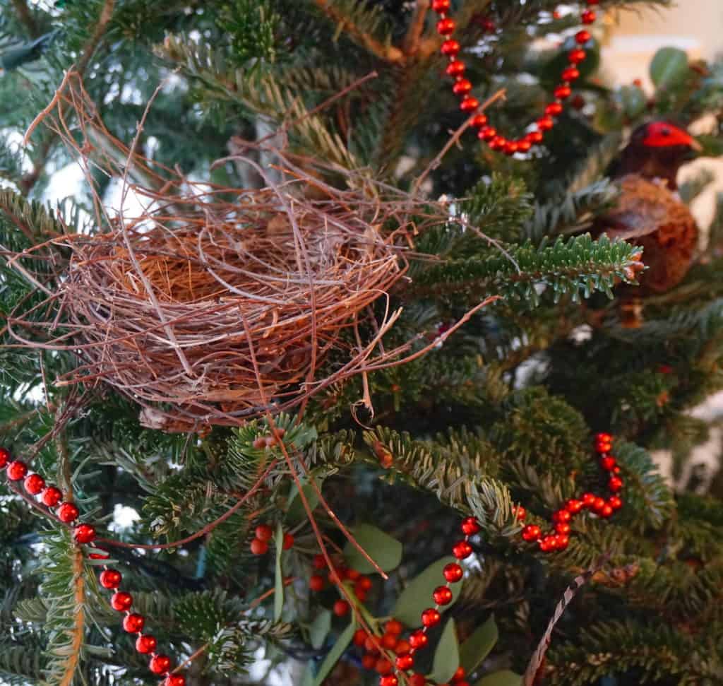 bird nest decorates a Christmas tree