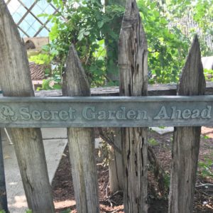 garden fence with Secret Garden ahead sign