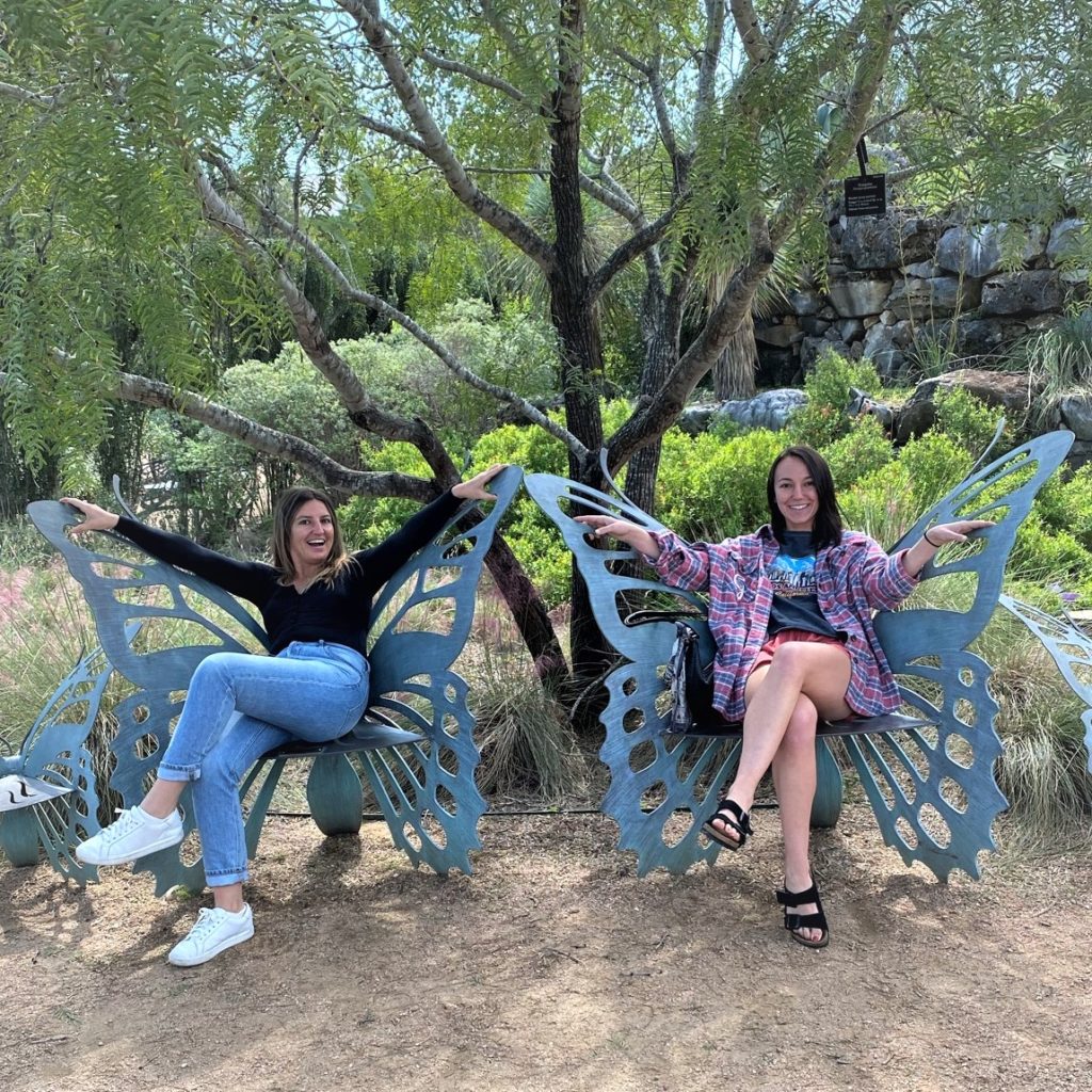 daughters delighting in butterfly benches at Lady Bird Johnson Wildflower Center