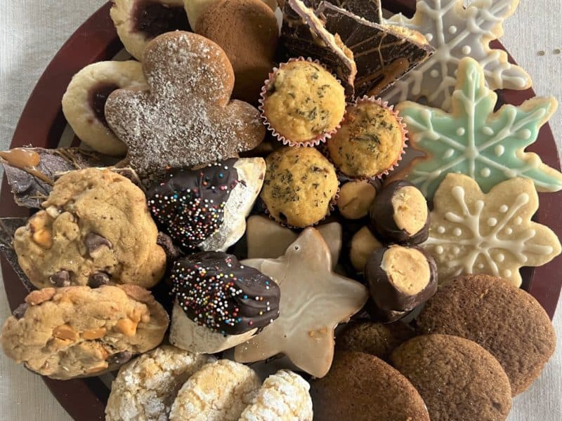 Christmas goodies fill a holiday plate, cookies from a neighborhood cookie exchange