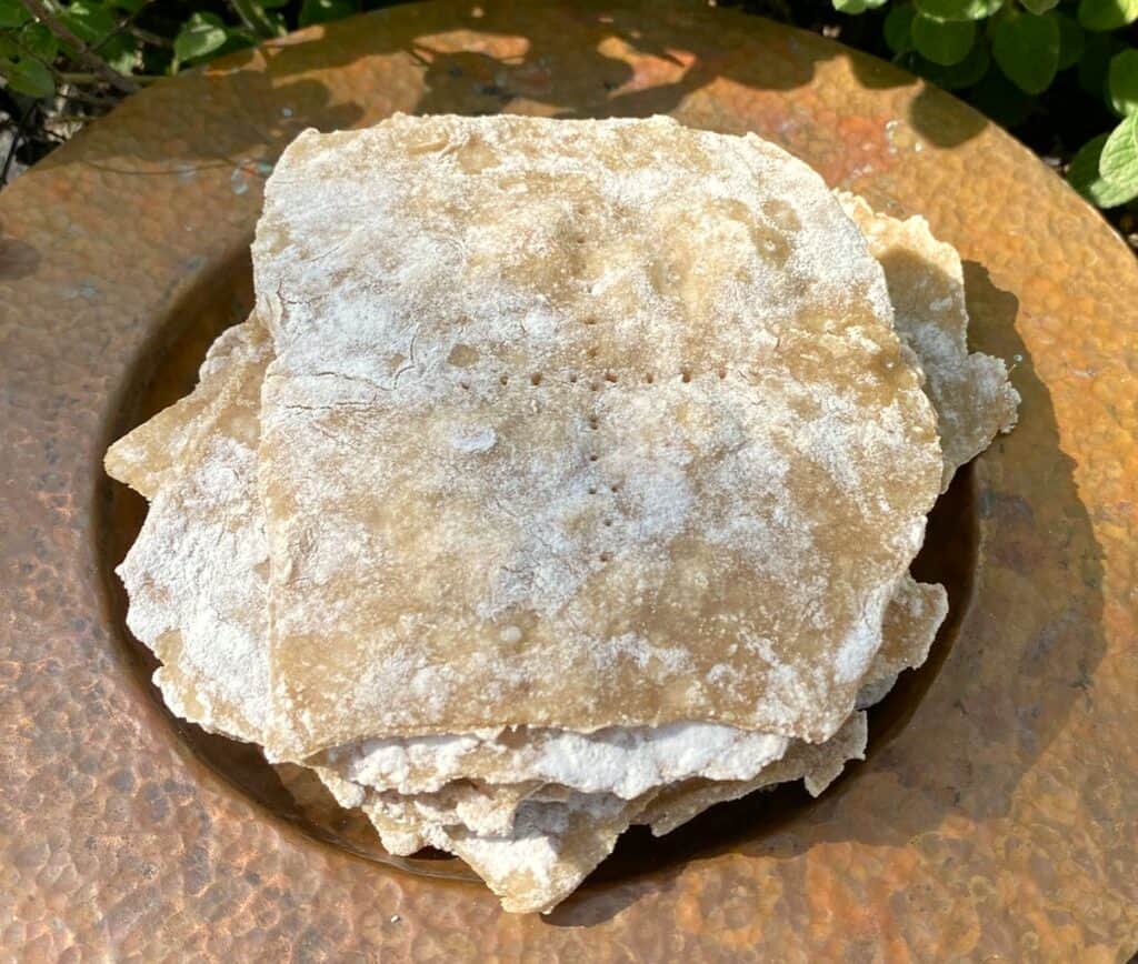 unleavened bread stacked on a copper plate
