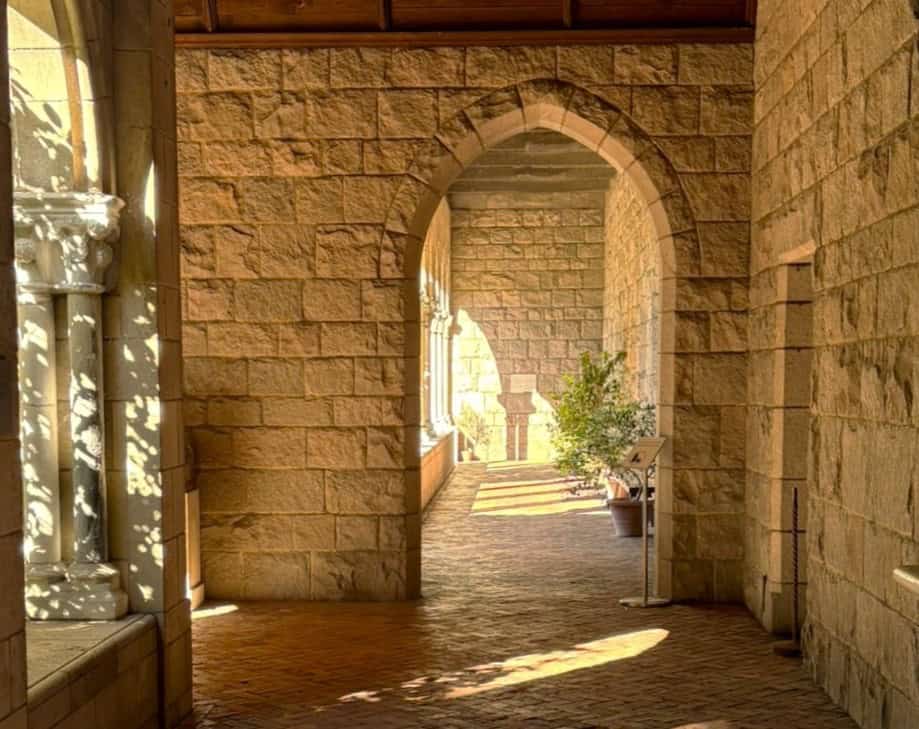 look down the arcade between garden sanctuaries at The Met Cloisters and spy a potted myrtle