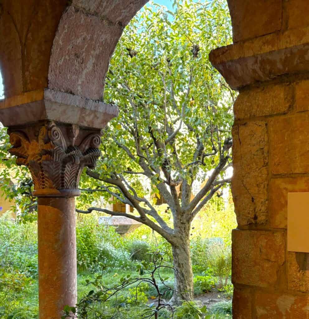 peek through the arcade columns to see a crab apple tree in this garden sanctuary in New York
