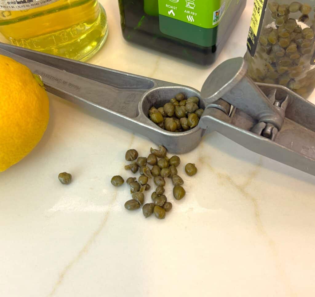 capers in a garlic press bring loads of flavor to salad dressing, 5 easy ways to enjoy herbs