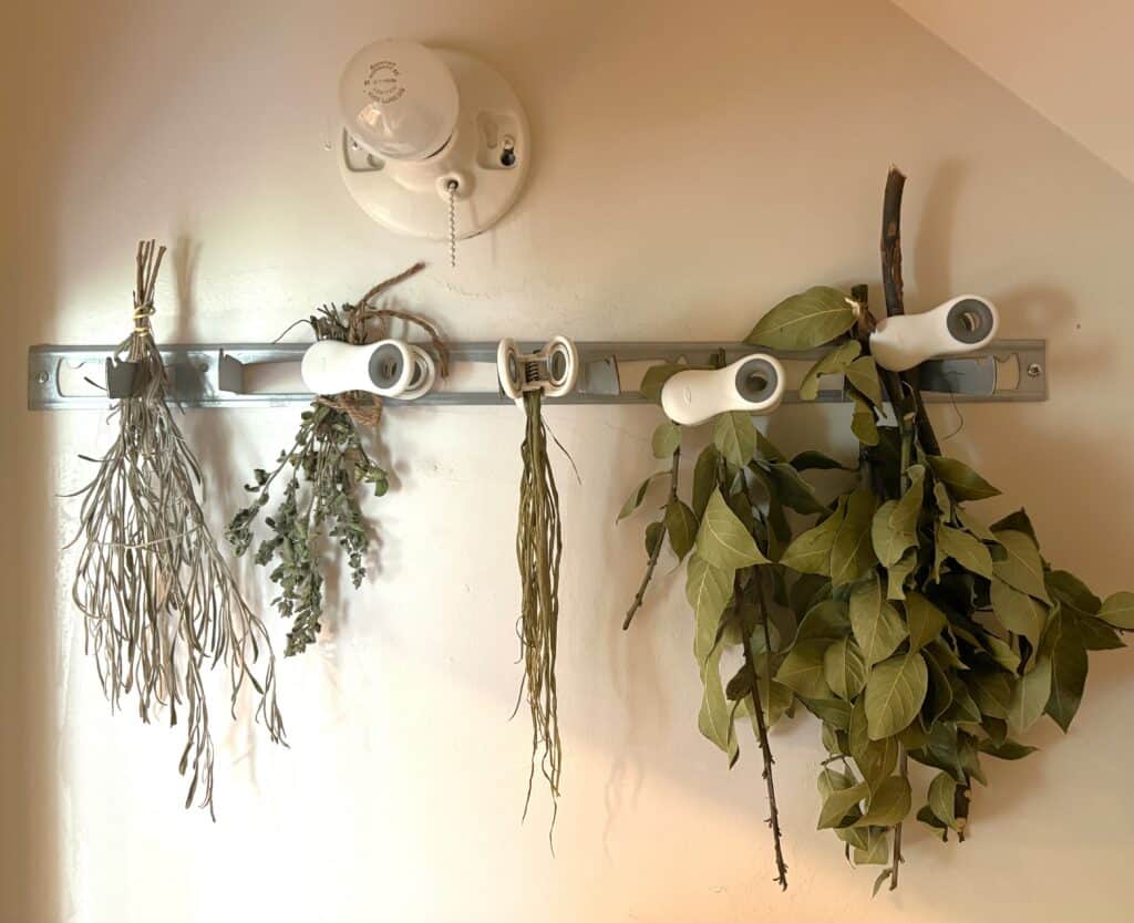 use a metal broom rack with magnetic clips to dry herbs in 5 easy ways to enjoy herbs
